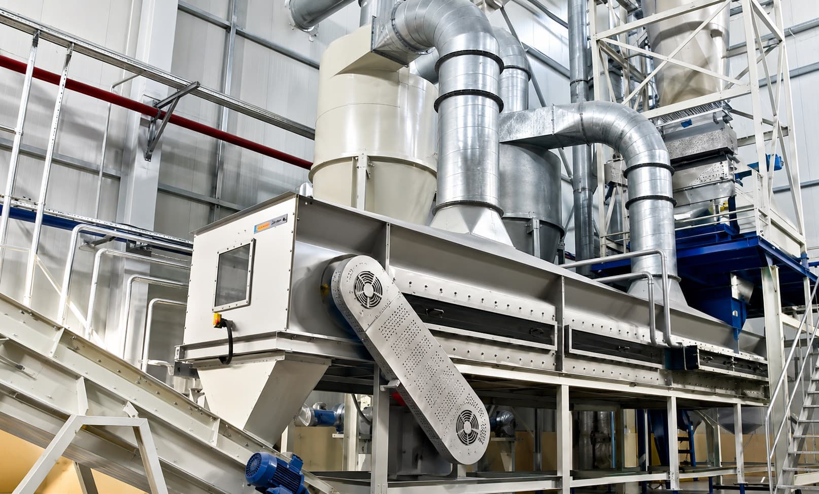 Inside Hasbiallah's feed processing facility, showing cyclone separators, ducting and conveyor equipment